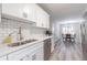 Renovated kitchen with stainless steel appliances, quartz countertops, and dining area views at 2038 Summertown Dr, Norcross, GA 30071