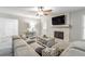 Bright living room with a stone fireplace, large sectional sofa, and an open layout at 2038 Summertown Dr, Norcross, GA 30071