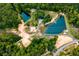 Expansive aerial view of property featuring mature trees, two ponds and unpaved access roads at 300 Old Boy Scout Rd, Whitesburg, GA 30185