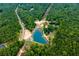 Aerial view showcases the community, multiple ponds, and lush greenery surrounding the property at 300 Old Boy Scout Rd, Whitesburg, GA 30185