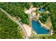 Stunning aerial view of the community with lush forest, picturesque ponds, and access roads at 300 Old Boy Scout Rd, Whitesburg, GA 30185