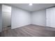 Bedroom with gray wood-look floors and white trim at 300 Old Boy Scout Rd, Whitesburg, GA 30185