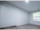 The bedroom features gray laminate wood flooring and a window overlooking a fenced in yard at 300 Old Boy Scout Rd, Whitesburg, GA 30185