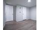 This bedroom includes a closet, painted walls, and wood-look flooring at 300 Old Boy Scout Rd, Whitesburg, GA 30185
