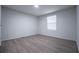 Bedroom boasts wood-look flooring, natural light, and neutral wall paint at 300 Old Boy Scout Rd, Whitesburg, GA 30185