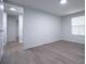 Bright bedroom with gray walls, wood-look flooring, and a window offering natural light at 300 Old Boy Scout Rd, Whitesburg, GA 30185