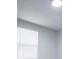 Bright bedroom features modern light fixture and window with horizontal blinds at 300 Old Boy Scout Rd, Whitesburg, GA 30185
