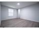 View of a gray walled bedroom with a window and attractive wood-look flooring at 300 Old Boy Scout Rd, Whitesburg, GA 30185