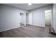 The bedroom features gray laminate wood flooring, neutral walls, an open doorway, and a walk-in closet at 300 Old Boy Scout Rd, Whitesburg, GA 30185