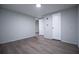 Bedroom with neutral walls, wood-look floors, and access to closet and hallway at 300 Old Boy Scout Rd, Whitesburg, GA 30185