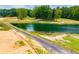 A view of the shared driveway leading to one of the ponds on the property at 300 Old Boy Scout Rd, Whitesburg, GA 30185