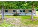 Exterior view of home featuring vinyl siding, black shutters and wood porch and stairs at 300 Old Boy Scout Rd, Whitesburg, GA 30185