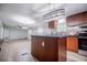 Updated kitchen with stainless appliances, center island, and modern lighting at 300 Old Boy Scout Rd, Whitesburg, GA 30185