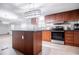Updated kitchen with a center island, wood cabinets, and stainless appliances at 300 Old Boy Scout Rd, Whitesburg, GA 30185