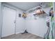 Functional laundry room with white walls, door, and shelves for organization at 300 Old Boy Scout Rd, Whitesburg, GA 30185