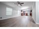Spacious open floor plan with a modern ceiling fan and wood-look flooring at 300 Old Boy Scout Rd, Whitesburg, GA 30185