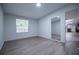 Bright living room with modern flooring, large windows, and a view into other rooms of the house at 300 Old Boy Scout Rd, Whitesburg, GA 30185