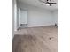 Empty room with an open doorway, gray walls, and wood look flooring at 300 Old Boy Scout Rd, Whitesburg, GA 30185