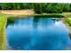 A view of one of the several ponds on the property with mature trees surrounding at 300 Old Boy Scout Rd, Whitesburg, GA 30185