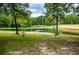A view of one of the several ponds on the property with mature trees surrounding at 300 Old Boy Scout Rd, Whitesburg, GA 30185