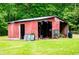 A view of the exterior of the shed on the property with mature trees in the background at 300 Old Boy Scout Rd, Whitesburg, GA 30185