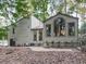 The back of this home features large windows and mature trees, perfect for nature lovers at 3771 Club Nw Dr, Kennesaw, GA 30144