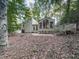 Well-maintained home with a deck, surrounded by a beautiful yard filled with mature trees at 3771 Club Nw Dr, Kennesaw, GA 30144