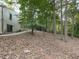 Backyard featuring mature trees and natural landscaping, with a path leading to the side of the home at 3771 Club Nw Dr, Kennesaw, GA 30144