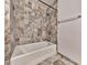 Bathroom featuring a tub and shower with mosaic style tile surround at 3771 Club Nw Dr, Kennesaw, GA 30144