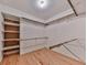 Walk-in closet featuring hardwood floors, wooden shelving, and clothing racks at 3771 Club Nw Dr, Kennesaw, GA 30144