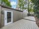 Spacious wooden deck with access to the house, surrounded by mature trees and natural landscaping at 3771 Club Nw Dr, Kennesaw, GA 30144