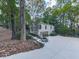 Exterior shot of a beautiful home with mature landscaping and a long driveway at 3771 Club Nw Dr, Kennesaw, GA 30144