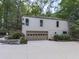 Well-maintained home exterior with a two-car garage and beautiful landscaping at 3771 Club Nw Dr, Kennesaw, GA 30144