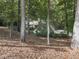 Exterior view of a beautiful home surrounded by mature trees and natural landscaping at 3771 Club Nw Dr, Kennesaw, GA 30144