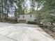 Detached garage with driveway, landscaping, and natural surroundings at 3771 Club Nw Dr, Kennesaw, GA 30144