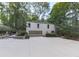 Spacious house with a large driveway and a two-car garage, surrounded by greenery, offering ample parking at 3771 Club Nw Dr, Kennesaw, GA 30144