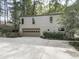 Detached garage with driveway, landscaping, and natural surroundings at 3771 Club Nw Dr, Kennesaw, GA 30144