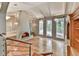 Living room with a striking fireplace, hardwood floors, built-in shelving, and multiple windows at 3771 Club Nw Dr, Kennesaw, GA 30144