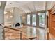 Living room with a striking fireplace, hardwood floors, built-in shelving, and multiple windows at 3771 Club Nw Dr, Kennesaw, GA 30144