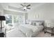 Bright bedroom with large windows, neutral decor, and a ceiling fan offering a tranquil retreat at 3774 Jack Vernon Cir, Powder Springs, GA 30127