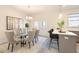 Well-lit dining area with a glass table, stylish chairs, island seating, and contemporary decor at 3774 Jack Vernon Cir, Powder Springs, GA 30127