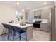 Contemporary kitchen featuring gray cabinets, stainless steel appliances, and a spacious quartz island at 3774 Jack Vernon Cir, Powder Springs, GA 30127
