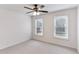Bright bedroom with neutral carpet, ceiling fan, and ample natural light, creating a relaxing retreat at 630 Dana Pointe Ct, Lawrenceville, GA 30045