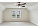 Bedroom with ceiling fan, large windows and plush carpet at 630 Dana Pointe Ct, Lawrenceville, GA 30045