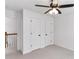 Simple bedroom featuring neutral carpet, a ceiling fan, and a closet, offering a blank canvas for personalization at 630 Dana Pointe Ct, Lawrenceville, GA 30045