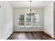 Bright dining room with wood floors, a modern chandelier, and a large window view at 630 Dana Pointe Ct, Lawrenceville, GA 30045