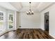 Elegant dining room with tray ceiling, modern lighting, and abundant natural light at 630 Dana Pointe Ct, Lawrenceville, GA 30045