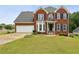 Charming two-story red brick home with a well-manicured lawn and attached two car garage at 630 Dana Pointe Ct, Lawrenceville, GA 30045