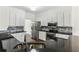 Modern kitchen featuring stainless steel appliances, granite countertops, and white cabinetry at 630 Dana Pointe Ct, Lawrenceville, GA 30045