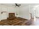 Cozy living room featuring a brick fireplace, built-in shelving, and hardwood floors at 630 Dana Pointe Ct, Lawrenceville, GA 30045